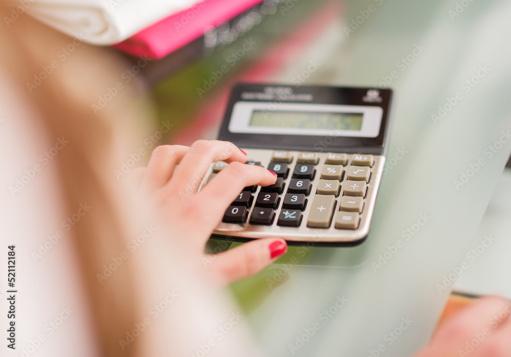 Close-up Of Female Hand Calculating Close-up Of Female Hand Calculating