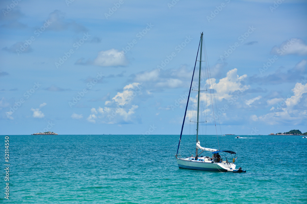 Sailboat on the sea with blue sky and cloudy
