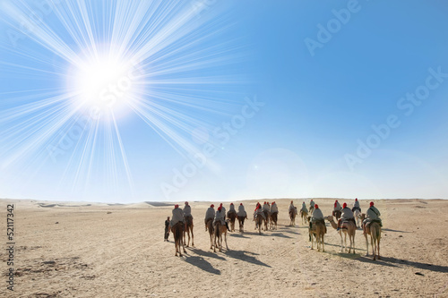 Sahara desert with sun and tourists