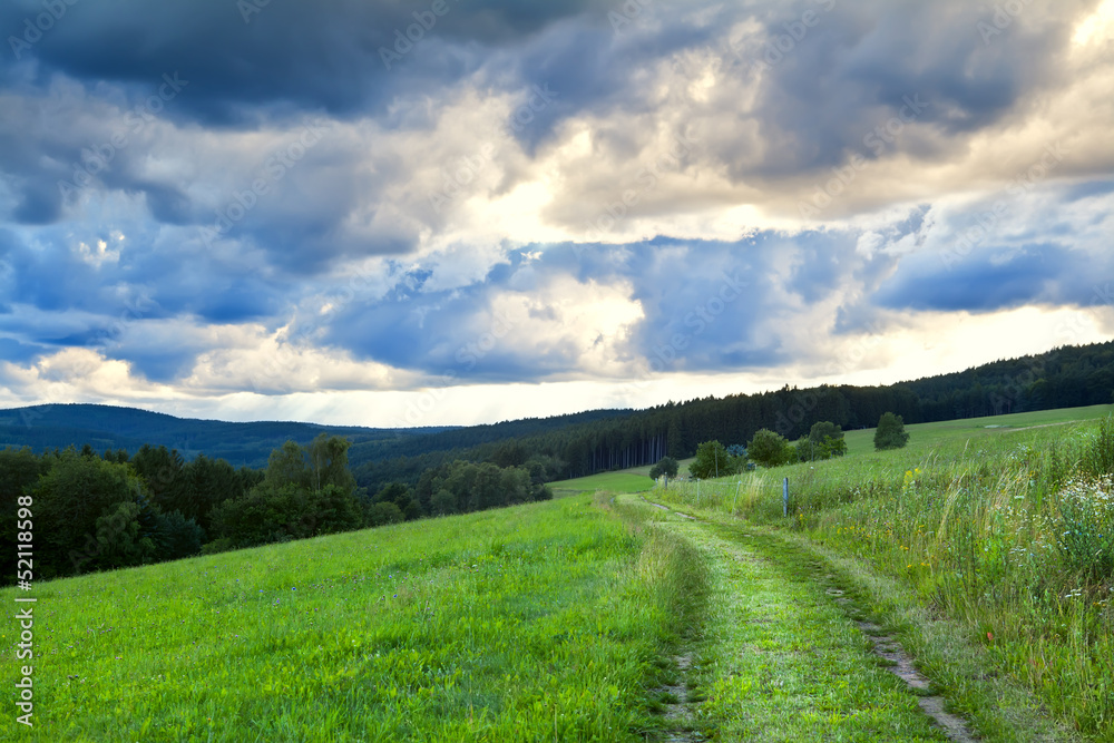 dramatic cloudscape over rural road