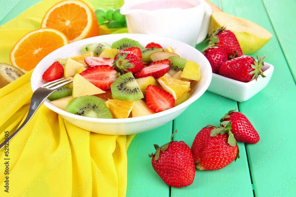 Useful fruit salad of fresh fruits and berries in bowl Useful fruit salad of fresh fruits and berries in bowl