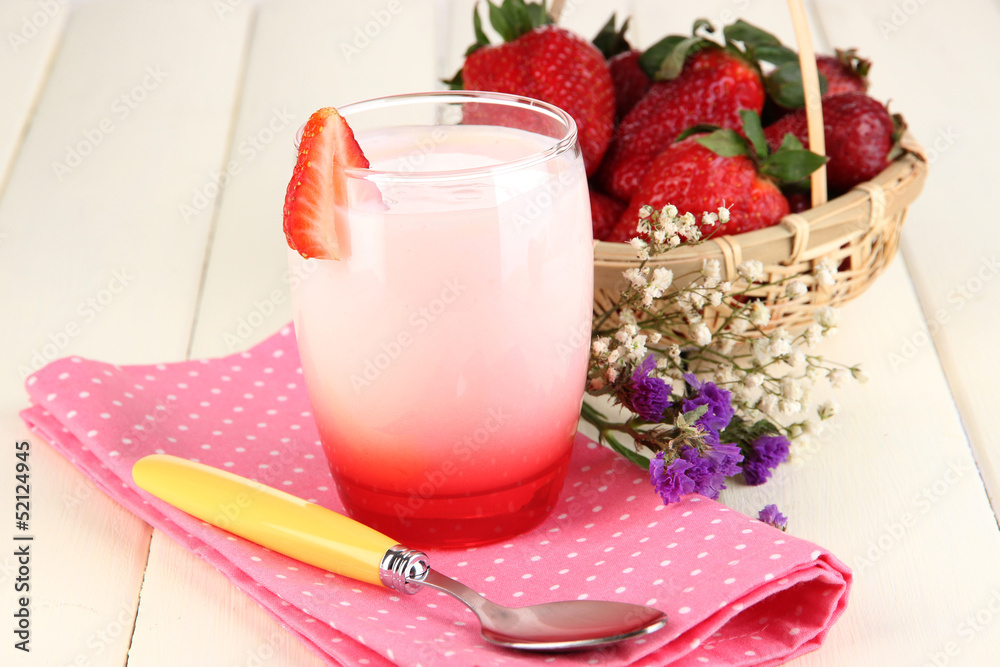 Delicious strawberry yogurt in glass on wooden table close-up Delicious strawberry yogurt in glass on wooden table close-up