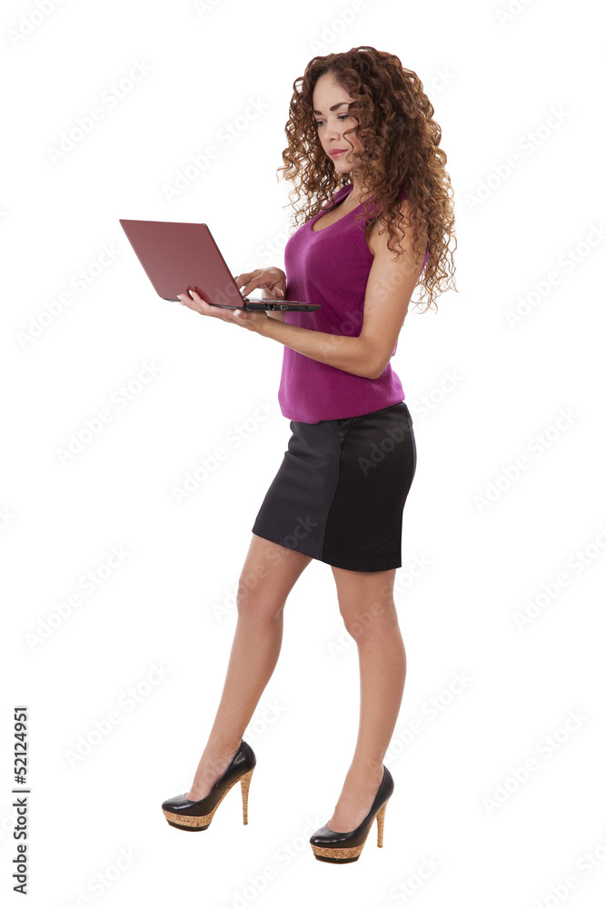 Woman in black skirt uses her computer while standing. Woman in black skirt uses her computer while standing.