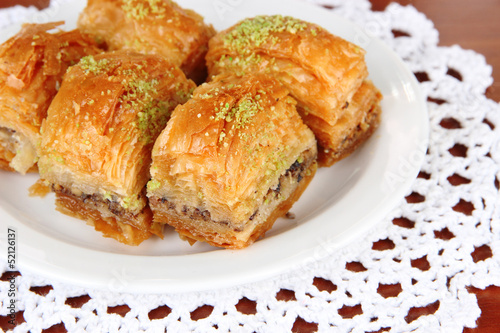 Sweet baklava on plate on table close-up