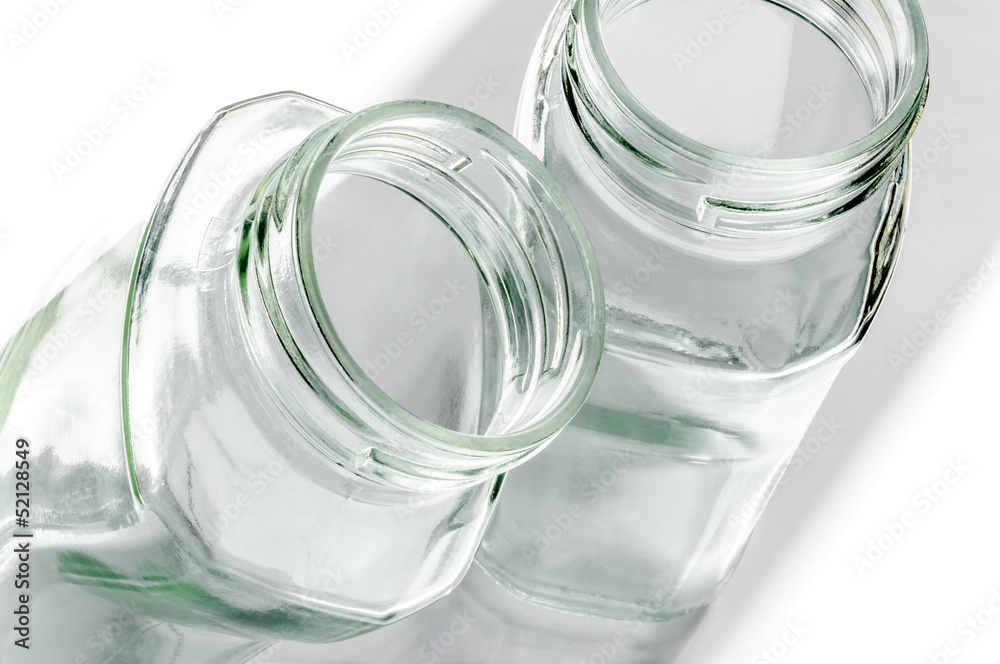 Transparent glass jars on white, with high-key effect Transparent glass jars on white, with high-key effect