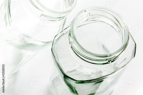 Transparent glass jars on white, with high-key effect