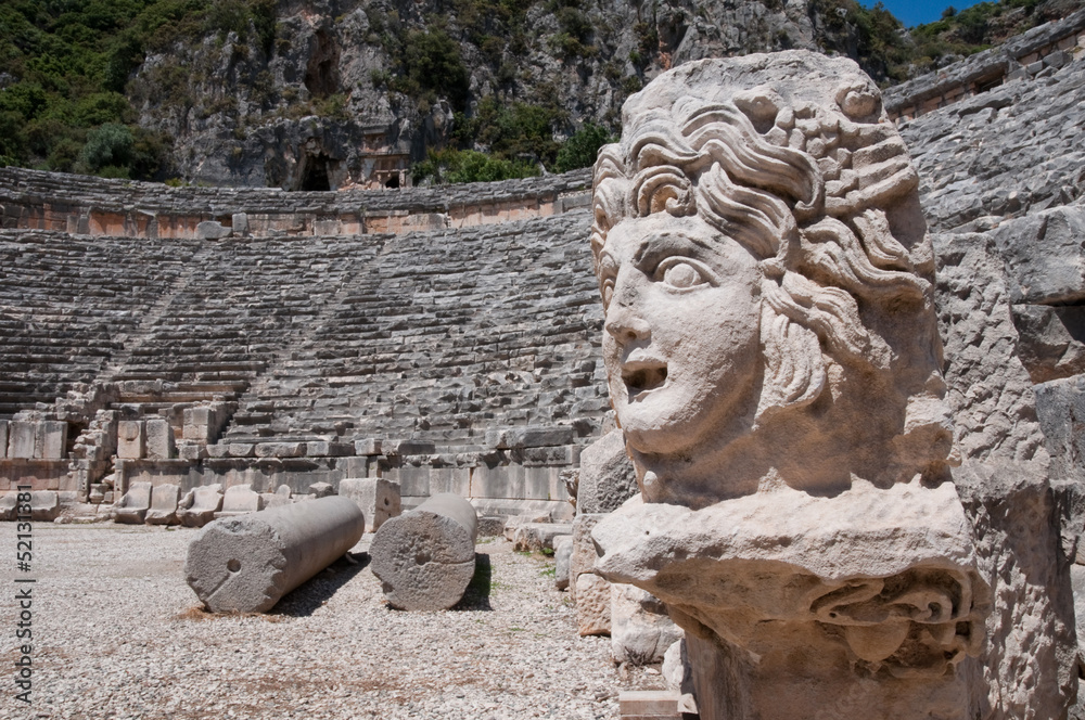 Stone mask and ancient amphitheater, Myra (Turkey )