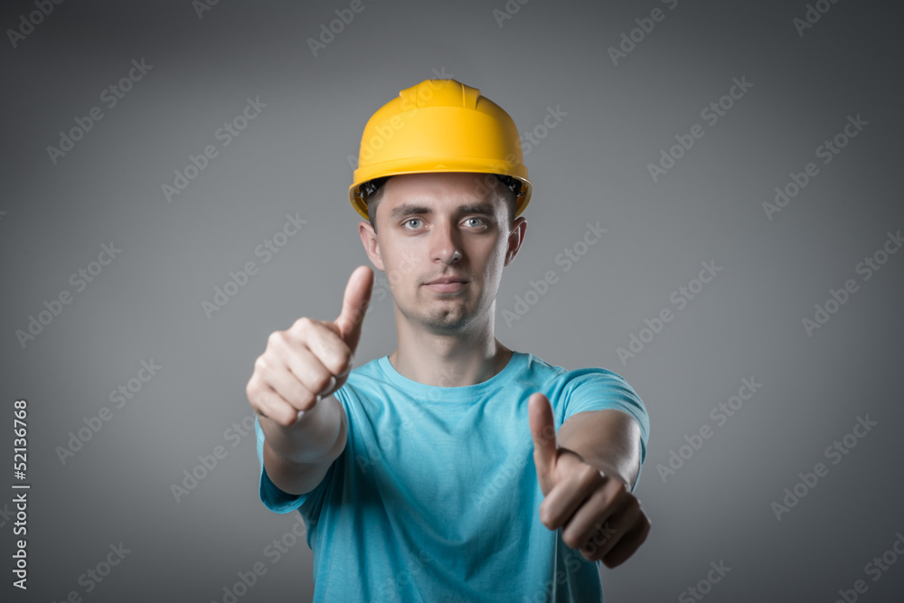 worker in helmet thumbs up