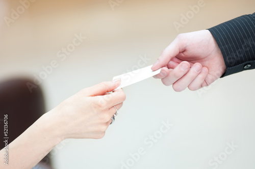 Exchange business card between man and woman.