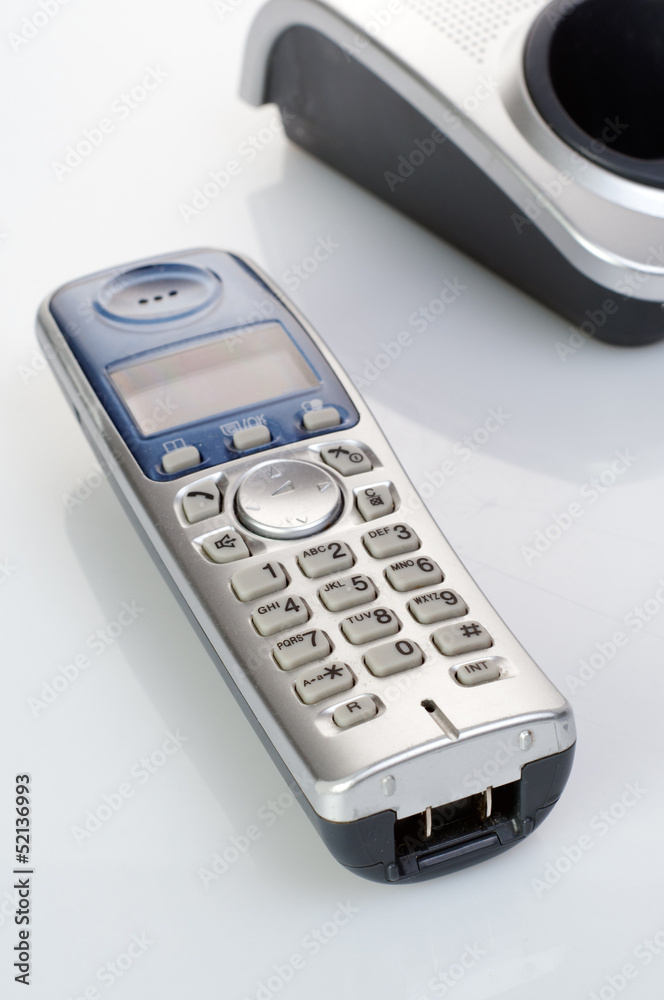 Wireless silver telephone with - cradle closeup shot Wireless silver telephone with - cradle closeup shot