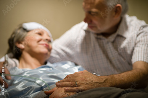 Old woman in pain lying bed photo