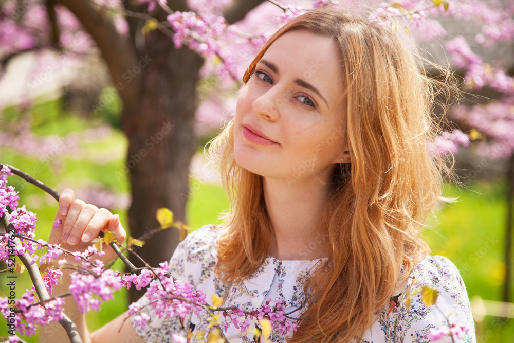 Fototapeta premium Beautiful woman in spring blossom