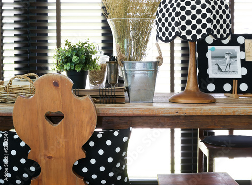 Wooden table and chair with a vintage polka dot lamp