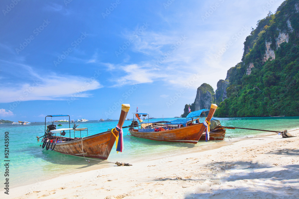 Tropical island with two boats and a bright sky Tropical island with two boats and a bright sky