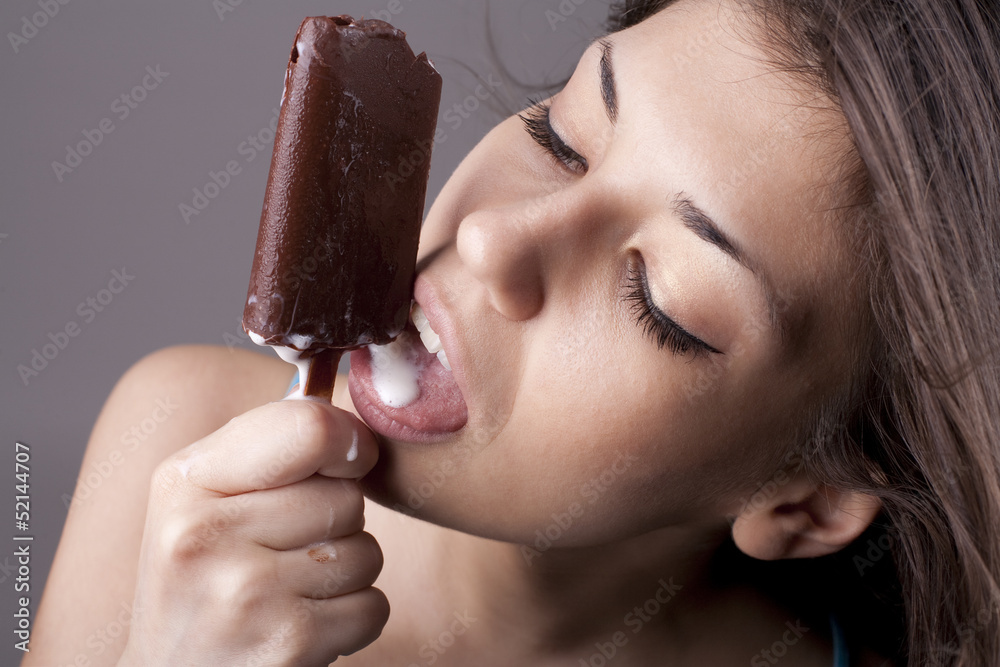 Sexy brunette woman licking chocolate Ice Cream Stock Photo | Adobe Stock
