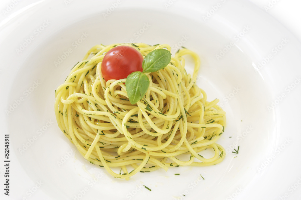 Italian spaghetti pasta with tomato and basil in white dish
