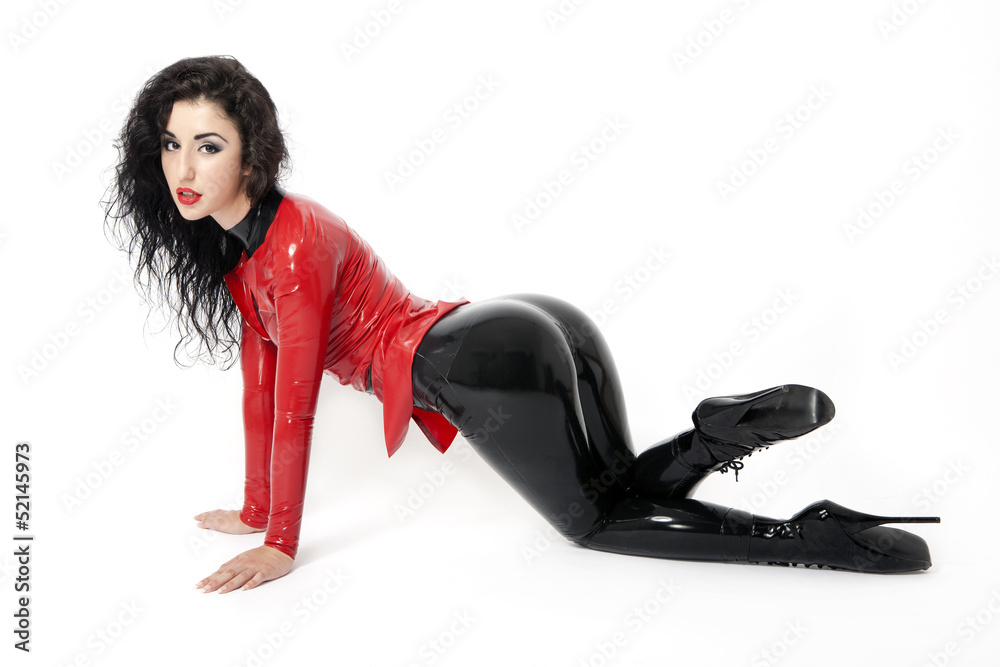 Sexy flexible brunette woman in black and red latex and boots foto de Stock  | Adobe Stock