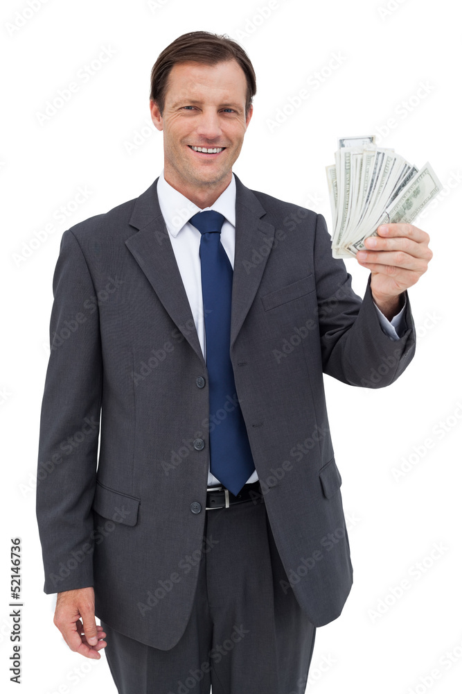 Smiling businessman holding dollar bills Smiling businessman holding dollar bills