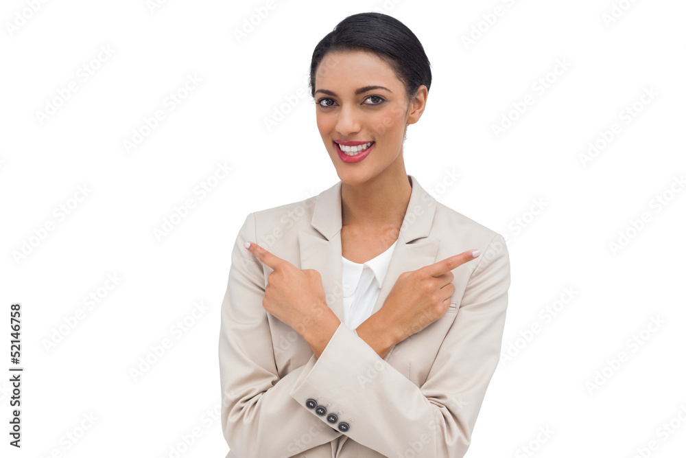 Cheerful businesswoman with her arms crossed and fingers pointin Cheerful businesswoman with her arms crossed and fingers pointin