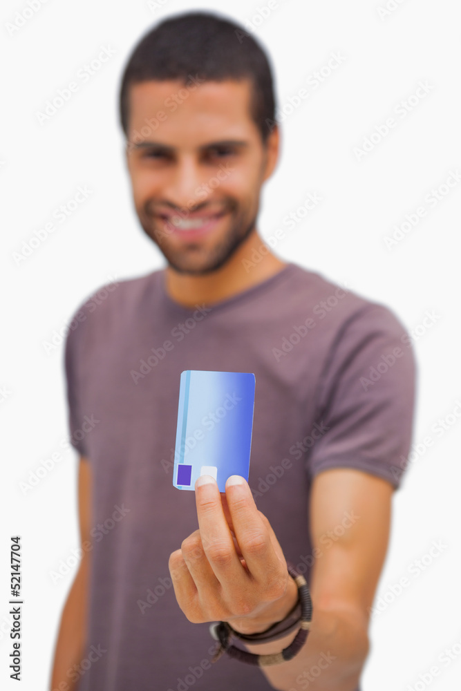 Smiling man holding credit card Smiling man holding credit card