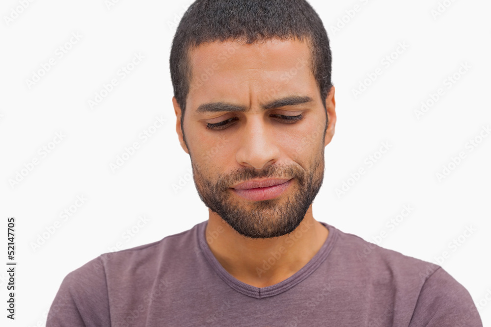 Fototapeta premium Handsome man frowning and looking down