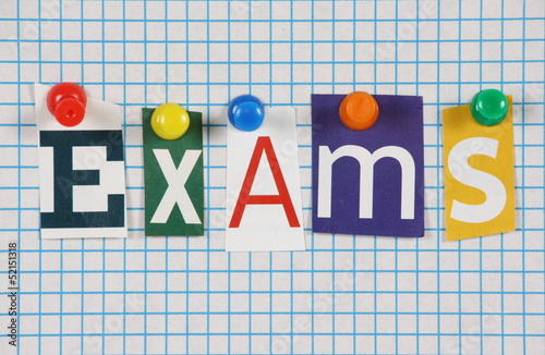 The word Exams in magazine letters on graph paper photo