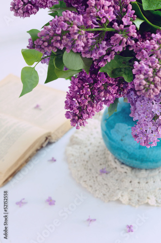 Beautiful lilac flowers in turquoise vase