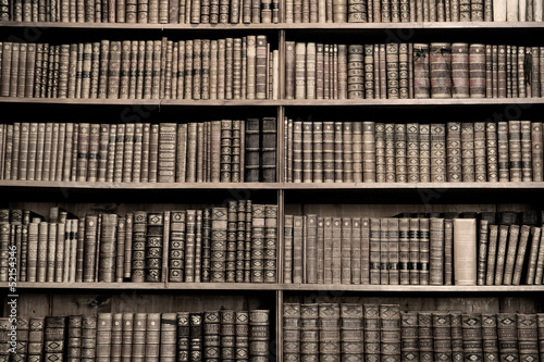 Old books in a library - sepia image
