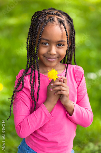 Outdoor portrait of a cute young black girl - African people