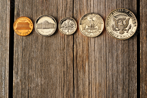 US cent coins over wooden background