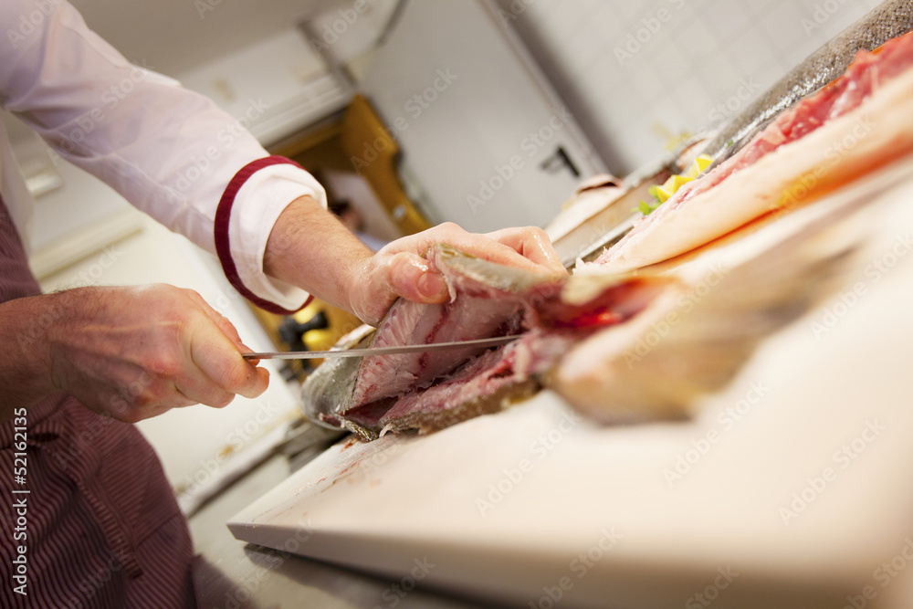 Chef cutting raw fish