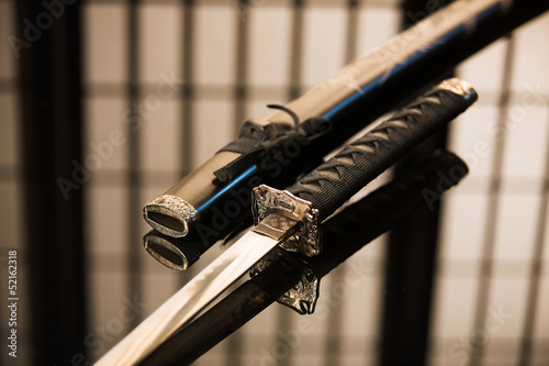 Katana with sheath reversed laying on table photo