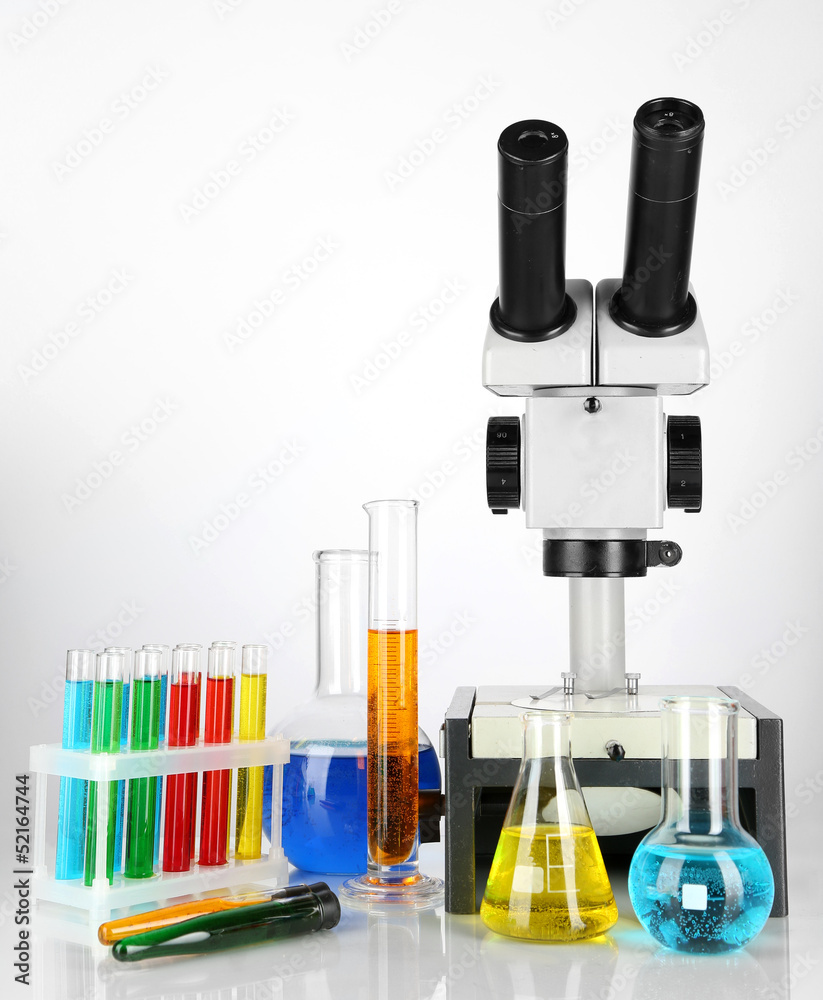 Test tubes with colorful liquids and microscope isolated Test tubes with colorful liquids and microscope isolated