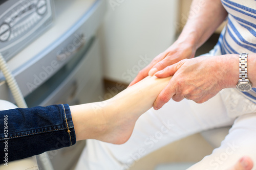 Pedicure giving client foot massage