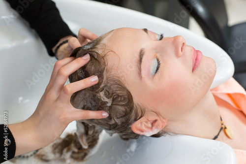 hairstylist washing customers hair