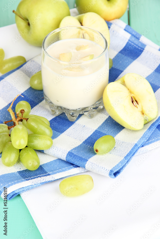 Delicious yogurt in glass with fruit on wooden table close-up Delicious yogurt in glass with fruit on wooden table close-up