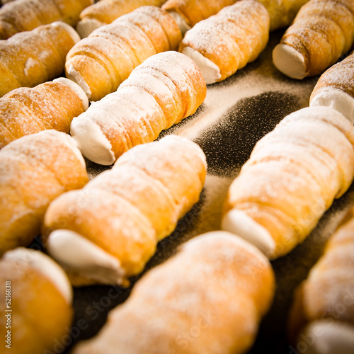 Cream horns decorated with powder sugar photo