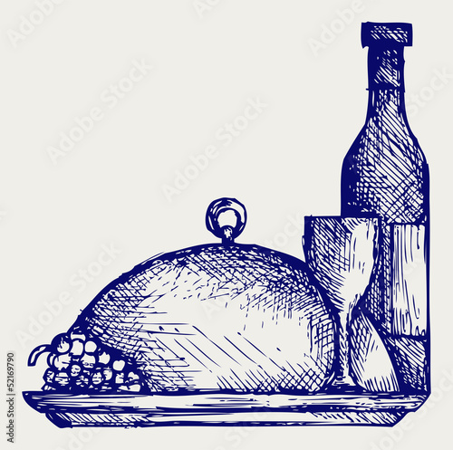 Grapes, bottles and glasses of wine on round tray