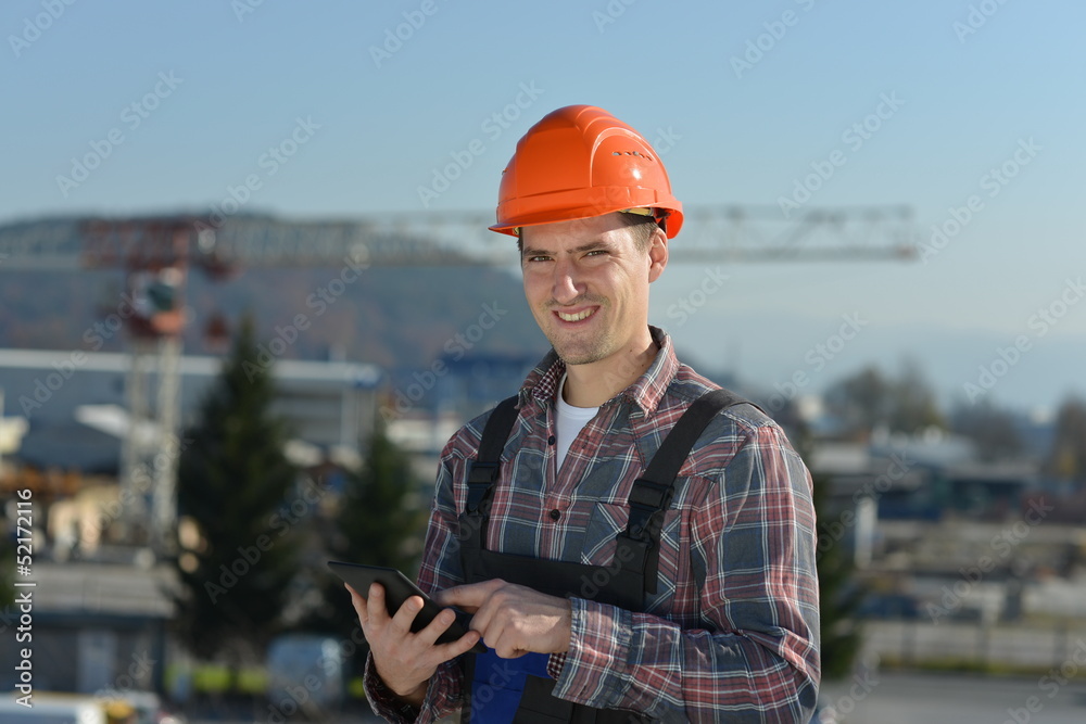 Engineer at construction site with a computer tablet Engineer at construction site with a computer tablet
