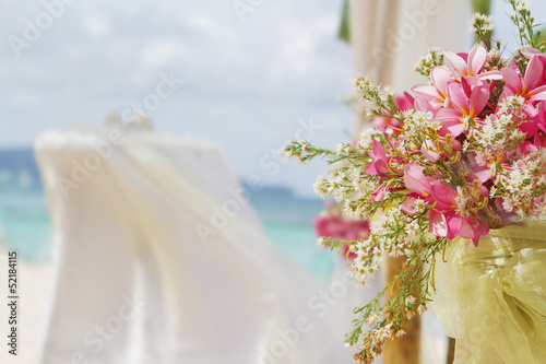 beautiful wedding setup and flowers on tropical beach background