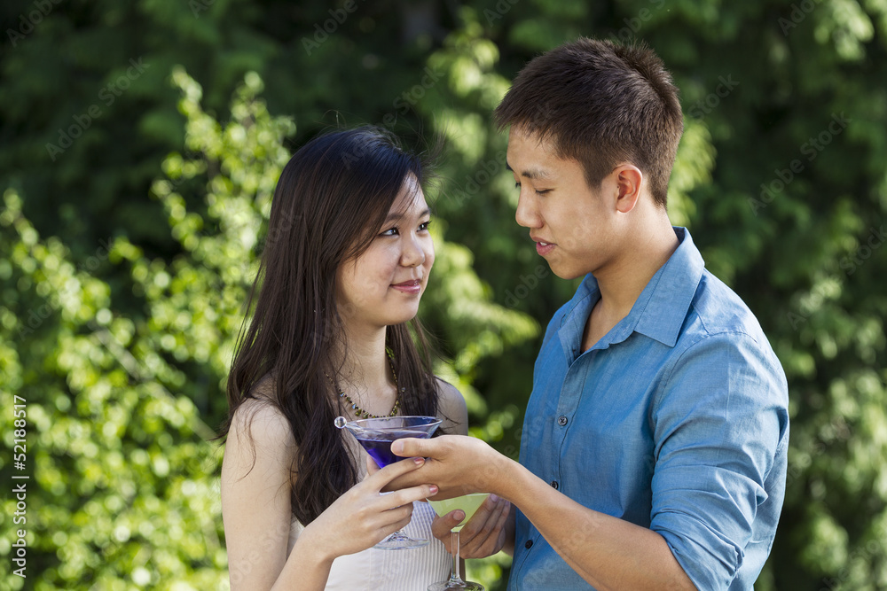 Young Adult Couple Sharing Drinks Outdoors Young Adult Couple Sharing Drinks Outdoors
