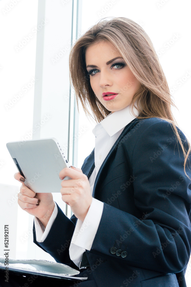 Young business woman using tablet PC Young business woman using tablet PC