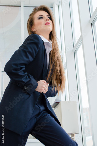 Young business woman wearing man's suit in office