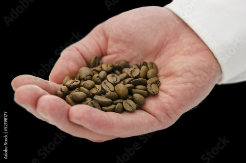 Coffee grains in male hand