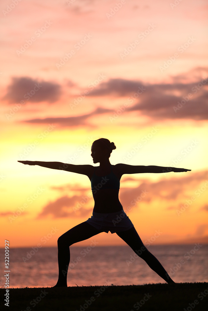 Yoga woman training and meditating in warrior pose