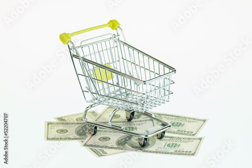 American hundred dollar bills and shopping cart