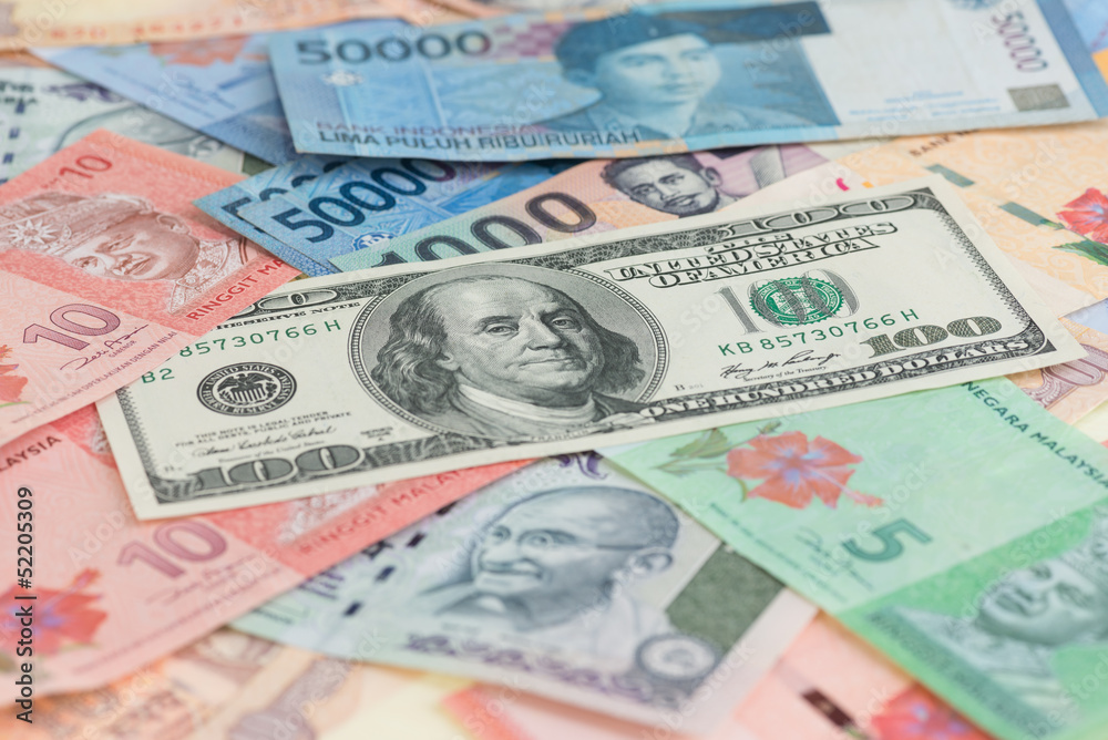 US hundred dollars bill and Asian currencies background US hundred dollars bill and Asian currencies background