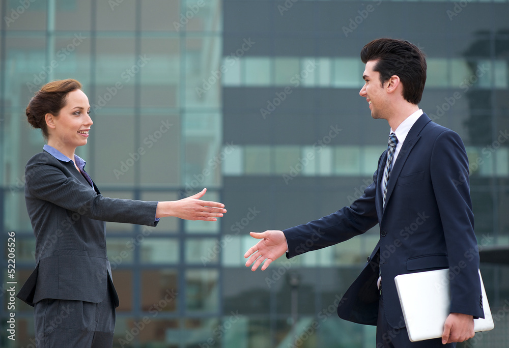 Businessman and business woman meeting with a handshake Businessman and business woman meeting with a handshake