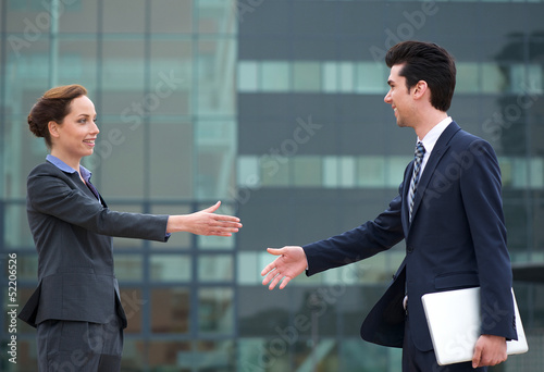 Businessman and business woman meeting with a handshake © mimagephotos