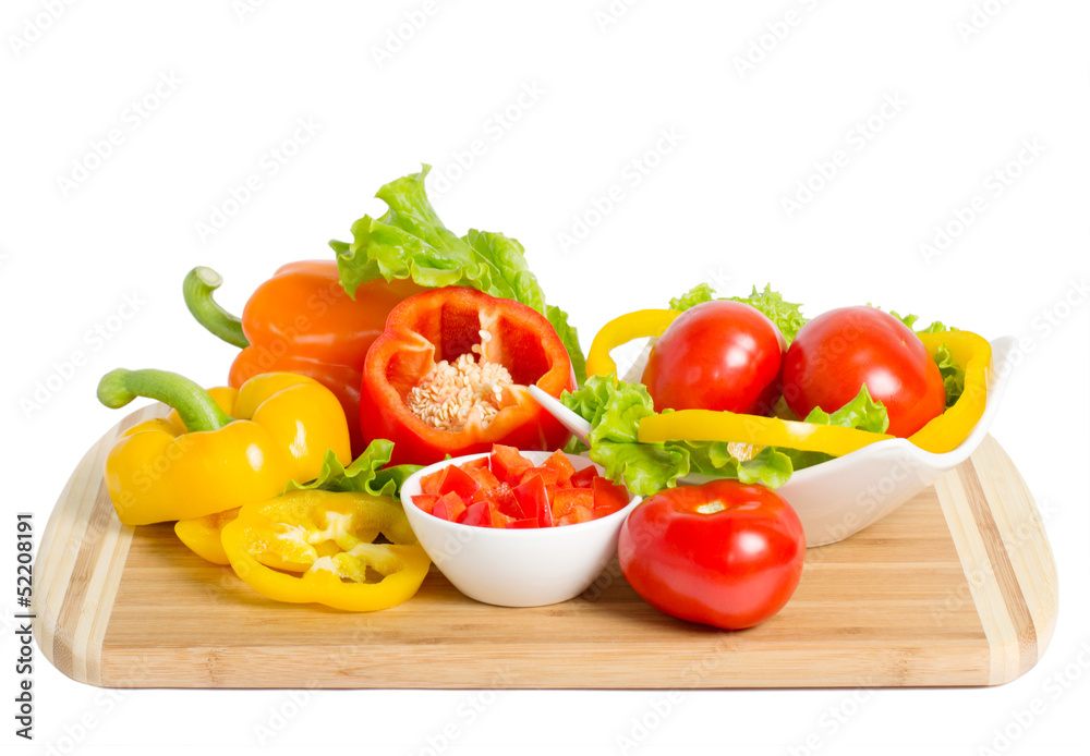 Bell peppers and tomatoes on the bamboo board